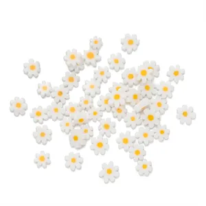 Macro view of assorted white and yellow daisy glass beads for DIY jewelry making
