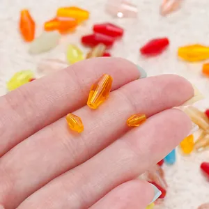 Detail of faceted orange glass beads in three sizes for DIY jewelry making