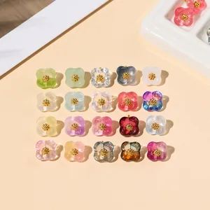 Macro view of transparent glass flower beads in 20 colors with golden stamens