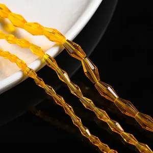 Macro view of three sizes of yellow faceted glass rhombic beads for jewelry making