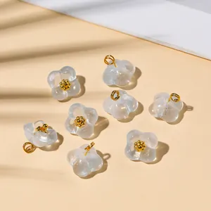Macro shot of 8 translucent frosted flower pendants with gold core for DIY jewelry making