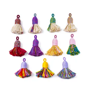 Detailed view of eleven assorted colorful handmade cotton tassels for DIY craft accessories