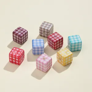 Macro shot of colorful gingham pattern acrylic cube spacer beads for DIY jewelry making