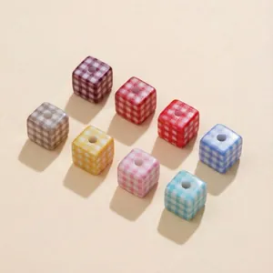 Macro shot of colorful gingham pattern acrylic cube beads for DIY jewelry making