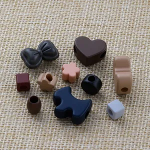 Detailed collection of colorful acrylic beads in heart, flower and bow shapes for DIY craft