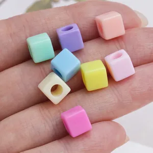 Hand holding 7mm macaron square beads for DIY necklace and bracelet jewelry making