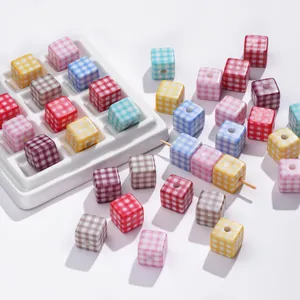 Detail of colorful checkered acrylic cube beads with holes for DIY jewelry making