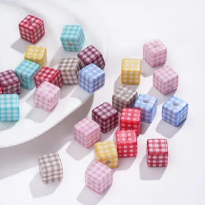 Close-up of colorful checkered acrylic cube beads for DIY jewelry and necklaces