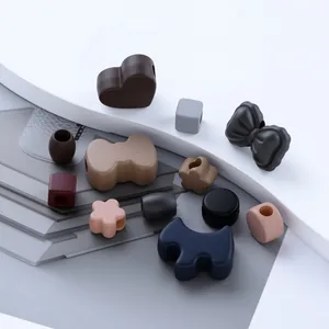 Close-up of assorted acrylic beads in vintage colors and various shapes for DIY phone chains