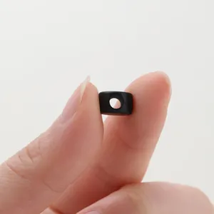 Close-up of a black matte mini drawstring toggle for DIY jewelry and phone chains