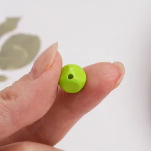Macro shot of 10mm bright green acrylic faceted bead for DIY jewelry making