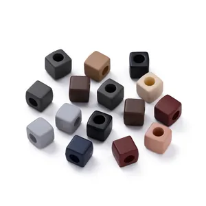 Close-up of matte Morandi colored acrylic square beads with center holes for DIY crafts