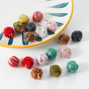 Macro shot of colorful mixed-color plush felt balls for handmade DIY jewelry crafts