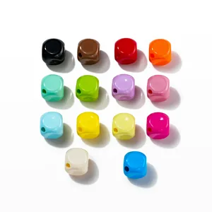 Close-up of 14 colorful 10mm acrylic square beads with smooth finish for DIY crafts