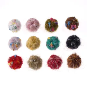 Macro view of 12 colorful fluffy felt balls for handmade DIY earring pendants