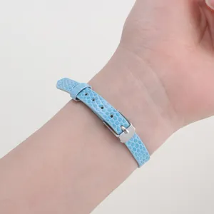 Detail of 8mm light blue faux lizard skin adjustable PU leather wristband with silver buckle
