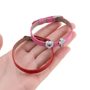 Detail of 8mm snake pattern PU leather wristbands with heart and cross rhinestone charms