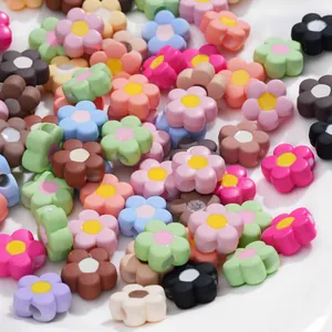Close-up of matte colorful acrylic flower beads with side holes for DIY jewelry making