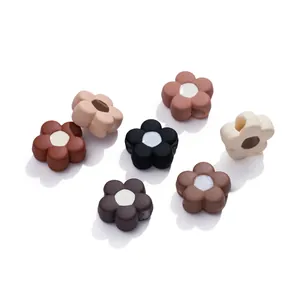 Macro view of flower-shaped acrylic beads with side holes for DIY jewelry making
