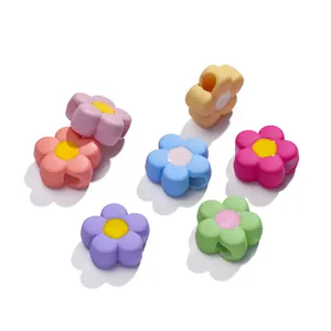 Macro shot of colorful acrylic flower beads with side holes for DIY jewelry making
