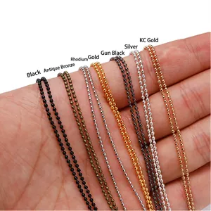Seven colors of metal ball chain necklace jewelry accessories held in a person's hand