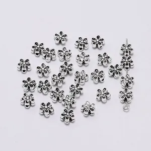 Macro detail of antique silver five-petal flower alloy spacer beads for DIY jewelry