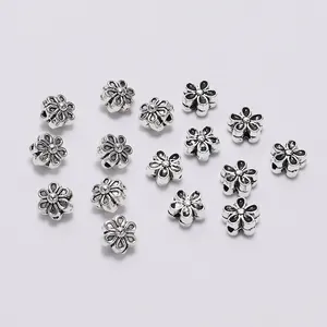 Macro detail of antique silver flower spacer beads for DIY jewelry bracelet making