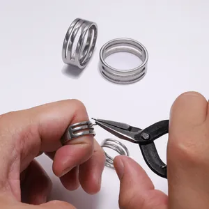 Macro detail of stainless steel jump ring opener tool with triple-layered hollow design