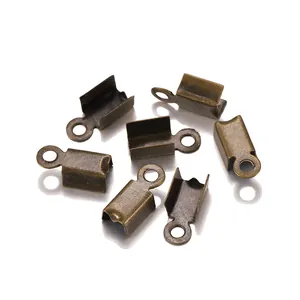 Macro shot of bronze fold-over cord crimp ends for DIY jewelry making accessories