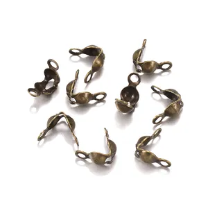 Macro shot of antique bronze jewelry clam shell bead tips with dual connector loops