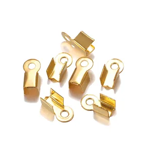 Close-up of golden U-shaped jewelry crimp ends with textured finish for DIY crafting