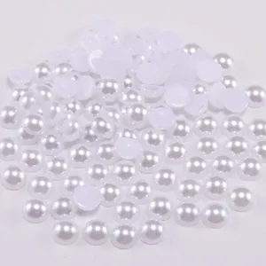 Macro shot of white half-round flatback pearls with lustrous finish for DIY crafts