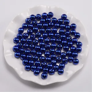 Macro view of navy blue round ABS imitation pearls with holes for DIY jewelry making