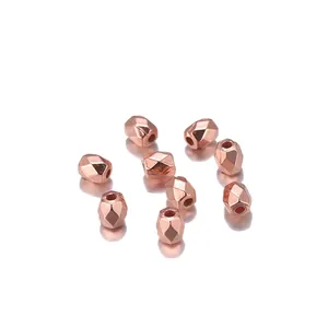 Macro view of rose gold faceted metal spacer beads with center holes for DIY jewelry making