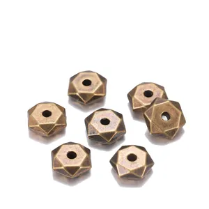 Detailed macro view of 7mm antique bronze faceted hexagon spacer beads for DIY jewelry