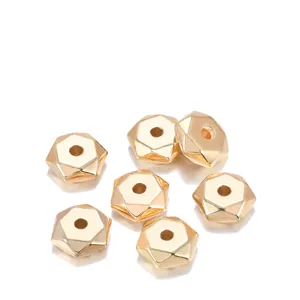 Close-up of 7mm golden CCB hexagon spacer beads with multi-faceted metallic finish