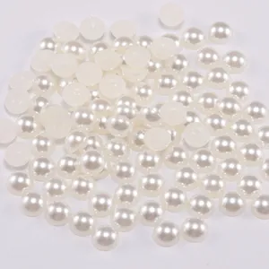 Detailed view of loose creamy white flatback ABS half pearls for DIY crafts and nail art