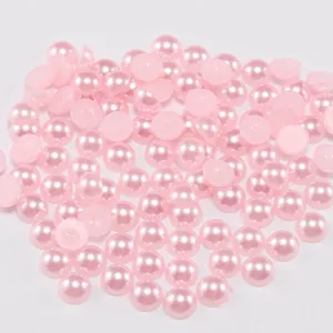 Macro view of pink half-round ABS flatback pearls with lustrous finish for DIY crafts