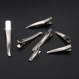 Macro view of assorted silver metal duckbill hair clips for DIY hairstyling accessories