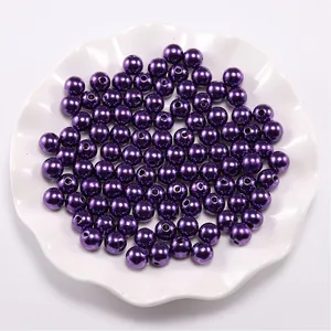 Macro shot of dark purple round ABS faux pearls with glossy finish for DIY jewelry craft