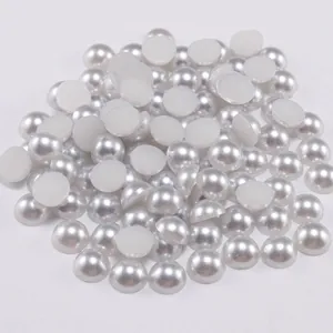 Close-up of bulk flatback white ABS faux pearls for DIY nail art and clothing decor