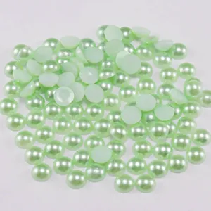 Detailed view of light green flatback ABS pearls with a pearl luster for jewelry DIY