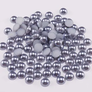 Macro shot of half round ABS faux pearls with metallic grey-purple sheen and flat back