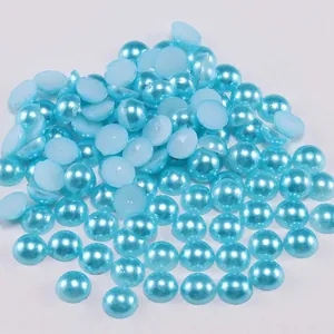Close-up of light blue flatback half pearls for DIY crafts and nail art decoration