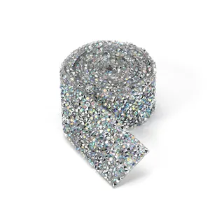 Macro shot of silver iridescent rhinestone ribbon roll with sparkling resin crystals for DIY