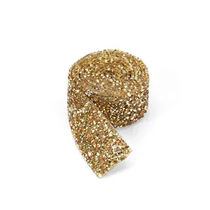 Close-up of golden resin rhinestone ribbon roll for DIY wedding dress and crafts decoration