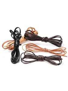 Macro shot of 2m flat genuine leather cords in black, brown, and tan for DIY jewelry making