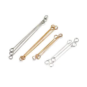 Detailed macro view of gold and silver plated metal eye pins for DIY jewelry making