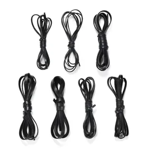 Detail of seven bundles of flat black leather cord for DIY jewelry and crafts making