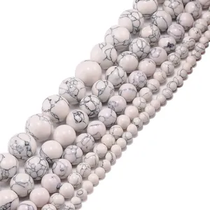 Macro detail of natural white howlite turquoise round beads with grey marble texture